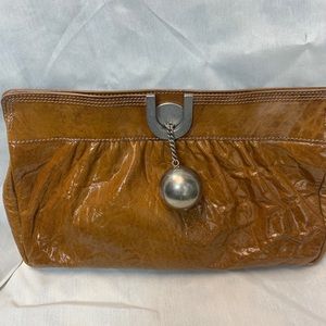 Chloe brown patent leather clutch with silver ball and chain.